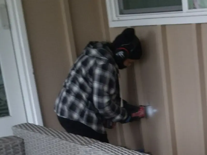 Professional electrician installing an exterior outlet in Lula